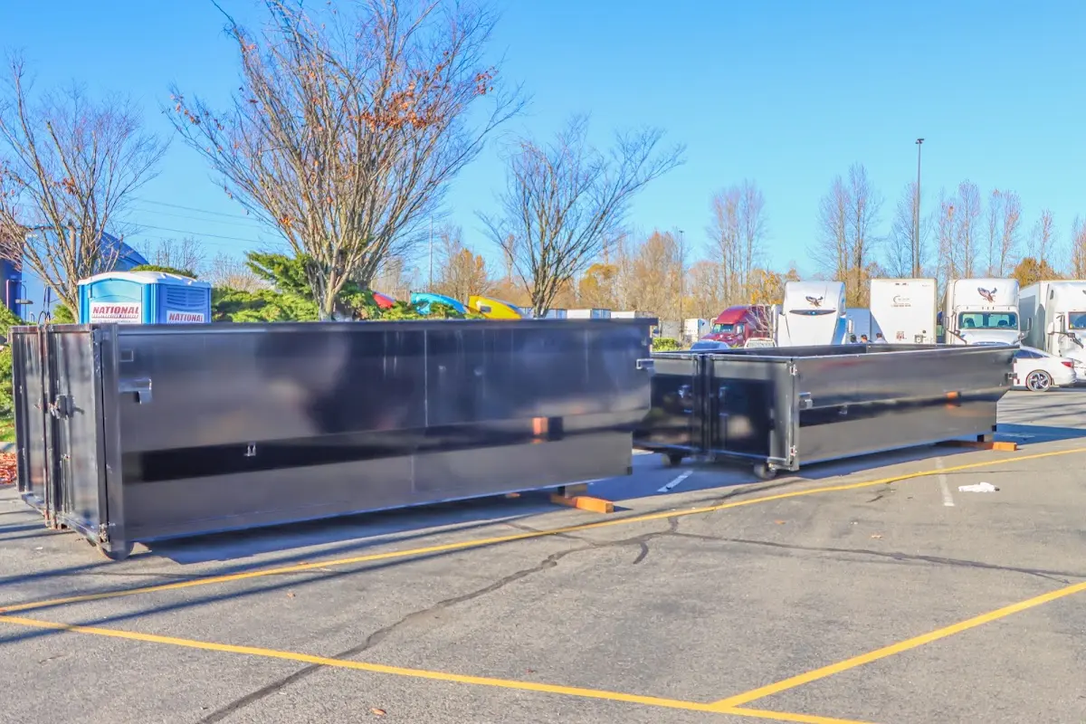 Professional dumpster rental service with roll-off container on residential driveway in Sartell